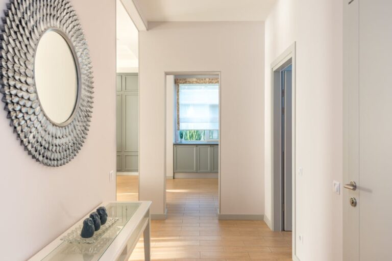 Minimalist interior hallway with wall art and natural light. Modern design.