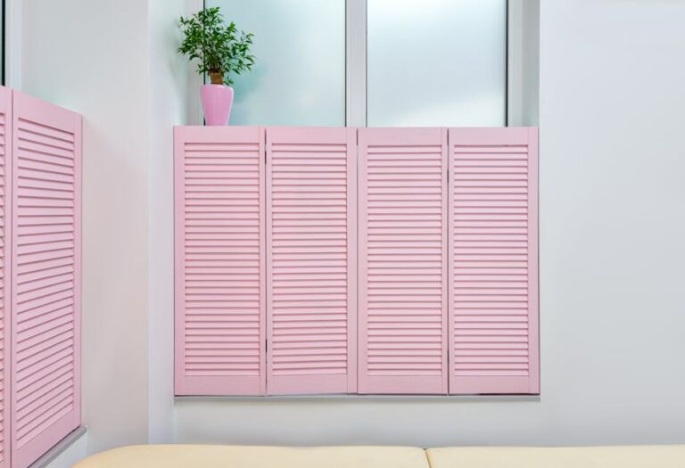 Minimalist interior of beauty office with couch for clients and pink shutters covering window