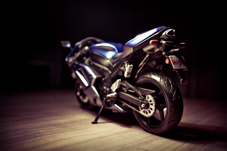 Artistic close-up of a blue sports motorcycle indoors, dramatic lighting accentuates its sleek design.